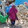 Somalis carry away the body of a civilian who was killed in a car bomb attack in Mogadishu, Somalia