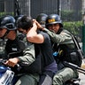 Venezuelan Bolivarian National Guard officers detain a demonstrator during clashes at Altamira Square in Caracas