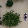 Residents evacuate their homes near the Addicks Reservoir as floodwaters from Tropical Storm Harvey rise Tuesday, in Houston