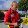Gas station employee Albert Fernandez covers a pump after running out of gas in Key Largo, Fla., Wednesday