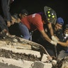 Rescue workers search a building that collapsed after an earthquake, in the Colonia Obrera neighborhood of Mexico City, Tuesday