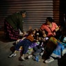 Families fearing aftershocks prepare to sleep on the street in the Roma neighborhood of Mexico City, Tuesday