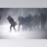People struggle to walk in the blowing snow during a the storm Tuesday, March 14, 2017, in Boston.