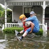 A Texas National Guard soldier carries a woman on his back as they conduct rescue operations in flooded areas around Houston, Sunday
