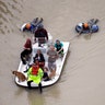 Evacuees make their way though floodwaters near the Addicks Reservoir as floodwaters from Tropical Storm Harvey rise Tuesday, in Houston