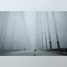 A car travels across the George Washington Bridge from New Jersey towards New York City in heavy falling snow.