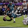 Philadelphia Eagles Zach Ertz dives over New England Patriots Devin McCourty for a fourth quarter touchdown in Super Bowl 52