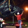 Workers remove a monument dedicated to the Confederate Women of Maryland early Wednesday, Aug 16, 2017