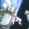 Two Astronauts Float in Space