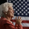 Former first lady Barbara Bush listens to her son, George W. Bush, as he speaks at an event in Orlando, Florida