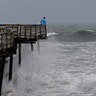 An onlooker checks out the heavy surf at the Avalon Fishing Pier in Kill Devil Hills, North Carolina, Thursday