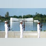 The U.S. Navy Ceremonial Guard performs a rifle salute 