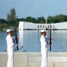 The U.S. Navy Ceremonial Guard performs a rifle salute 