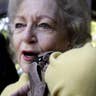 Betty White cozies up to a South American python at the Los Angeles Zoo