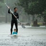 Alexendre Jorge evacuates Ethan Colman, 4, from a neighborhood inundated by floodwaters from Tropical Storm Harvey, in Houston, Monday