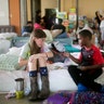 Volunteer Elizabeth Hill, 8, plays with evacuee Skyler Smith, 7, at a shelter at St. Thomas Presbyterian Church in west Houston, Tuesday