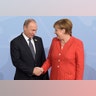 Russian President Vladimir Putin shakes hands with German Chancellor Angela Merkel at the G-20 summit in Hamburg, Germany
