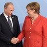 Russian President Vladimir Putin shakes hands with German Chancellor Angela Merkel at the G-20 summit in Hamburg, Germany