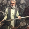 Antique gun store's owner, Tawakal, holds the handmade 