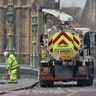 Cleaners sweep up on Westminster Bridge in London, March 23, 2017.