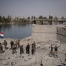 Iraqi Special Forces soldiers celebrate after reaching the bank of the Tigris river in Mosul, Iraq, July 9