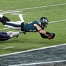 Philadelphia Eagles Zach Ertz scores a fourth quarter touchdown over New England Patriots free safety Devin McCourty in Super Bowl 52