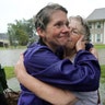 Amanda Ankney hugs her mother Sharon Gilleon after her parents were rescued from flood waters in Houston, Monday