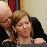 Vice President Joe Biden talks to Stephanie Carter as her husband Ash Carter speaks in Washington February 17, 2015