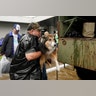 Volunteers load pets into a collector's vintage military truck to evacuate them from flood waters from Hurricane Harvey in Dickinson, Texas