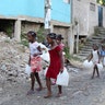 Children carry containers for water as Hurricane Irma approaches on Wednesday, in Santo Domingo, Dominican Republic