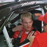 Dale Earnhardt, Jr. listens to a crew member before a practice session at Lowe's Motor Speedway, May 5, 1999