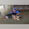 Joe Garcia carries his dog Heidi from his flooded home as he is rescued from rising floodwaters Monday, in Spring, Texas