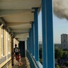 A man watches smoke rise from the apartment building fire in London