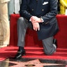 Moore kneels in front of his newly unveiled star on the Hollywood Walk of Fame on October 11, 2007