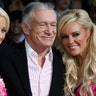 Hugh Hefner poses with Holly Madison, left, and Bridget Marquardt in 2008.