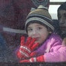 A child reacts from inside a bus evacuating people from a rebel-held sector of eastern Aleppo, Syria December 15, 2016. REUTERS/Abdalrhman Ismail 