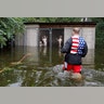 Dogs that were left caged by an owner, who fled rising flood waters from Hurricane Florence, are rescued in Leland, N.C., on Sunday.