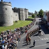 Police officers and members of the public watch as military personnel rehearse their part in the procession, in Windsor, May 17, 2018