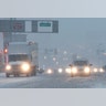 Vehicles drive drive through snow as they approach the Holland Tunnel, Thursday, Feb. 9, 2017, in Jersey City, N.J. 