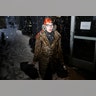A woman working at Fashion Week makes her way to the venue through heavy snow in New York.