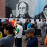 People lineup to enter to a poll station during the election for a constitutional assembly in Caracas, Venezuela