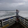Patrick Wells looks out over the Atlantic ocean at the Avalon Fishing Pier in Kill Devil Hills, North Carolina, Thursday