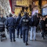French cops patrol outside the Galeries Lafayette department store in Paris, on Tuesday, a day after a truck ran into a crowded Christmas market in Berlin.