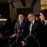 French Interior Minisnter Bruno le Roux, center left, Defense Minister Jean-Yves le Drian and Culture Minister Audrey Azoulay answer reporters inside the Louvre Museum.