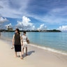 Tourists walk the beach in Tumon, Aug. 10, 2017.