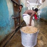 Prisoner pulls a large stock pot filled with rice and beans during lunch inside the National Penitentiary in downtown Port-au-Prince, Haiti. 