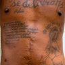 The tattoo on his chest reads in Haitian Creole: 