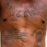 The tattoo on his chest reads in Haitian Creole: 