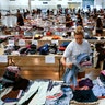 Volunteer Paige Atkinson sorts donated clothing at NRG Center, which opened its doors to  evacuees