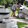 Residents remove flood damaged items from their home as they cleanup after Tropical Storm Harvey